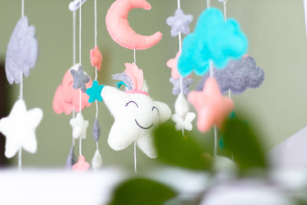 istock Textile soft toys rotate over the baby's crib. mobile for the cradle. 1347063644