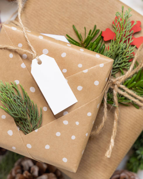 istock Christmas present with blank gift tag and decorations, Mockup 1347063804