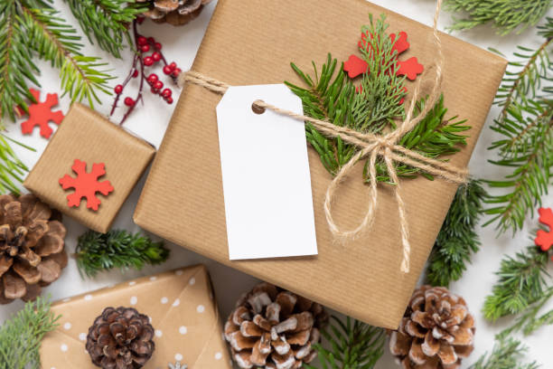 istock Christmas present with blank gift tag and decorations, Mockup 1347063805