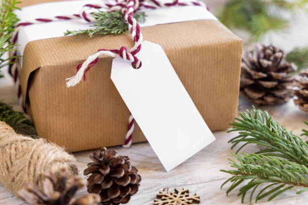 istock Christmas present with blank gift tag and decorations, Mockup 1347063812