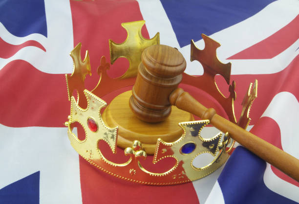 istock King crown with judge gavel on UK flag. 1347064790