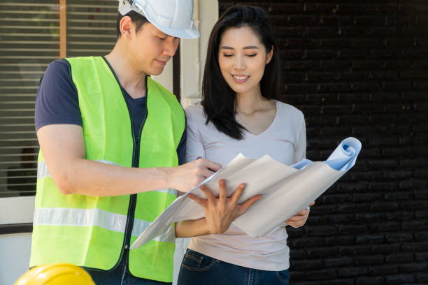 istock Asian professional architect holding blueprint and explain about the plan with homeowner for house renovation and design for home construction building, Concept of architecture and home interior 1347065708