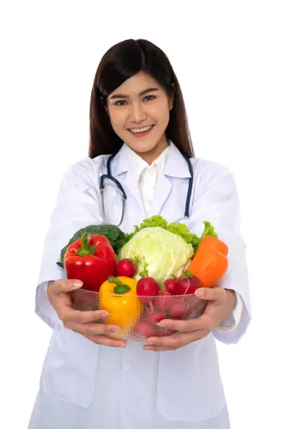 Photo of Doctor or nutritionist holding fresh fruit (Orange, red and green apples) and smile in clinic. Healthy diet Concept of nutrition food as a prescription for good health, fruit is medicine