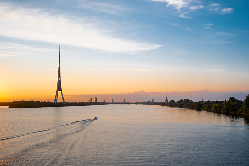 Riga old town panorama and TV tower. Sunset over the Daugava river