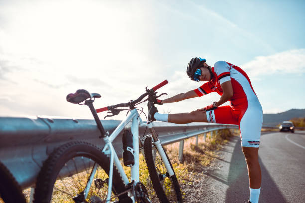istock Female Cyclist Taking Break From Riding And Stretching Out Legs Before Second Part Of Journey 1347070799