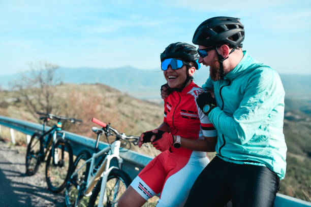 istock Cyclist Couple Embracing While Taking Break From Riding And Leaning On Railing 1347070818