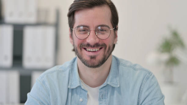 istock Portrait of Young Man Smiling at Camera 1347073295