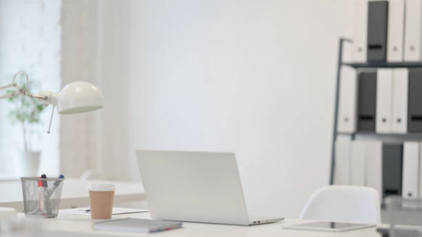 istock Minimalist Office with Open Laptop on Desk 1347073517