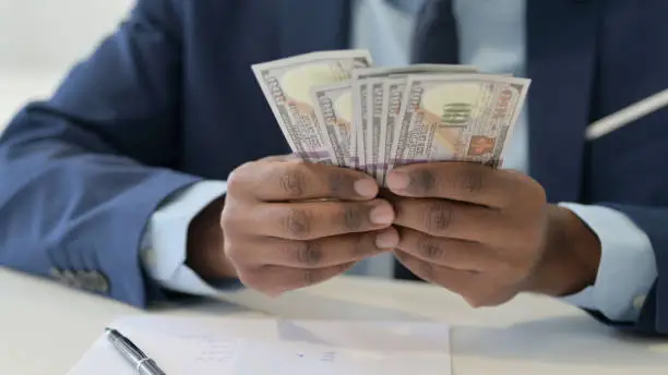 Hands of Businessman Counting Dollars, Close Up