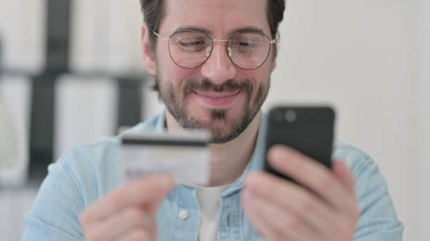 istock Close up of Successful Online Payment on Smartphone by Man 1347075892