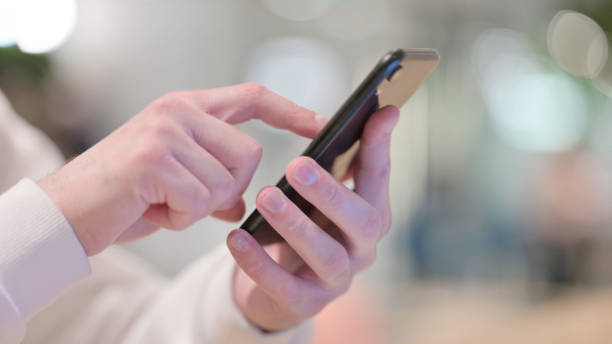 istock Close up of Man using Smartphone Outdoor 1347076084