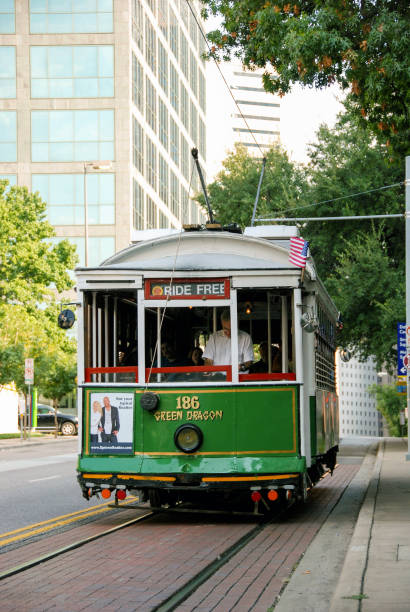 Head on view of the vintage street tram on McKinney Avenue in downtown Dallas Dallas, Texas, USA - September 2009: A trolley car on the McKinney Avenue trolley system trolley bus stock pictures, royalty-free photos & images