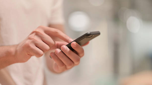 istock Close up of Male Hands using Smartphone 1347076294