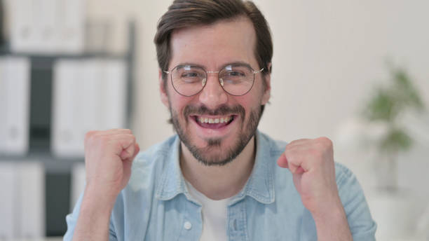 istock Portrait of Successful Young Man Celebrating 1347076450