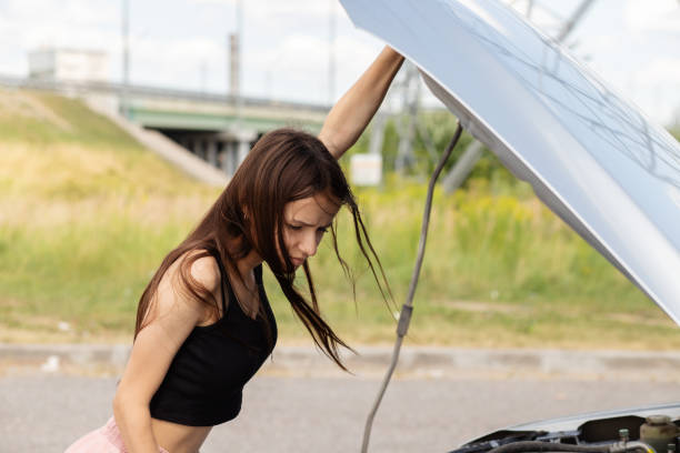 istock woman driver having trouble with her broken car 1347077100