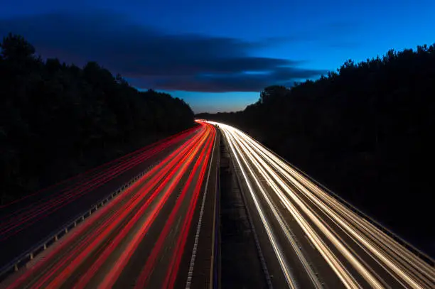 Wide angle view of cars traveling on a motorway at dusk.