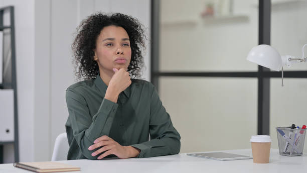 istock Pensive African Woman Thinking at Work 1347077659