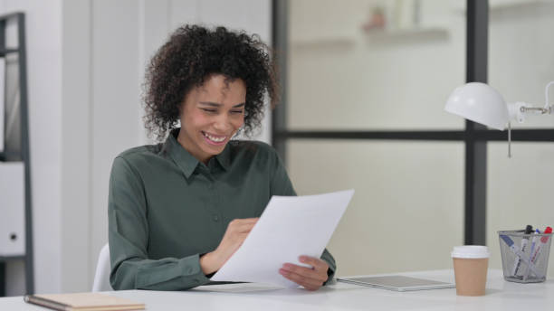 istock African Woman Celebrating while Reading Papers 1347078561