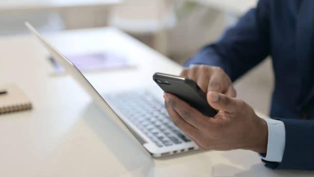 istock African Businessman Using Smartphone at Work, Close Up 1347078781
