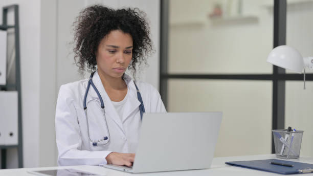 istock Female African Doctor Working on Laptop 1347078847