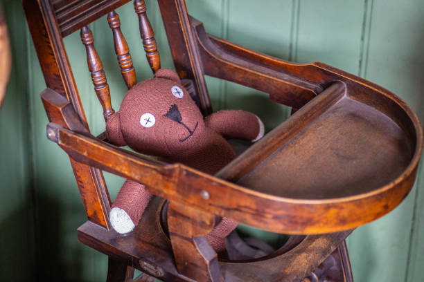 istock Cloth teddy in child’s high chair 1347078939