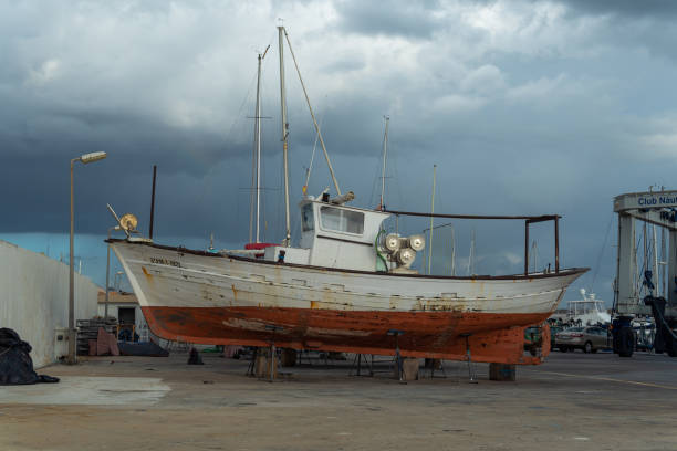 recreational boat supported on metal tripods for future restoration. sa rapita marina, island of mallorca, spain - industrial ship shipping painting repairing imagens e fotografias de stock