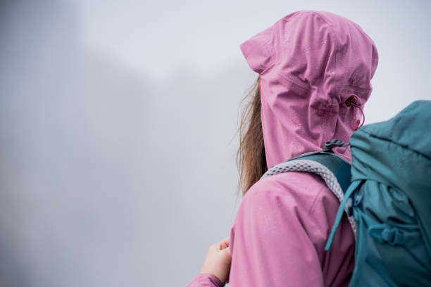 istock Young woman hikes along through dense fog 1347079955