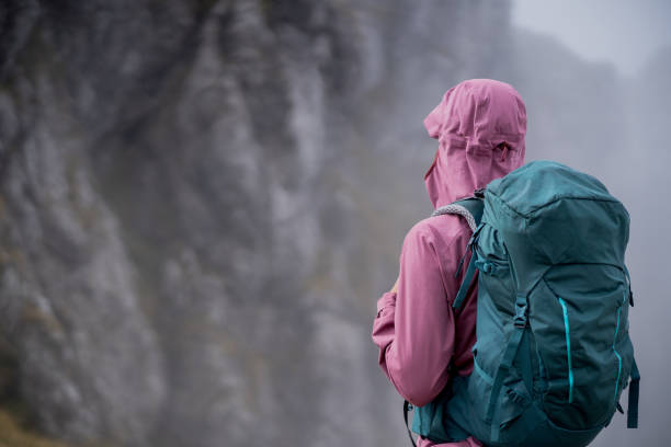 istock Young woman hikes along through dense fog 1347079995
