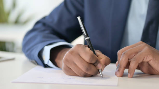 istock African Businessman Writing on Paper 1347080534