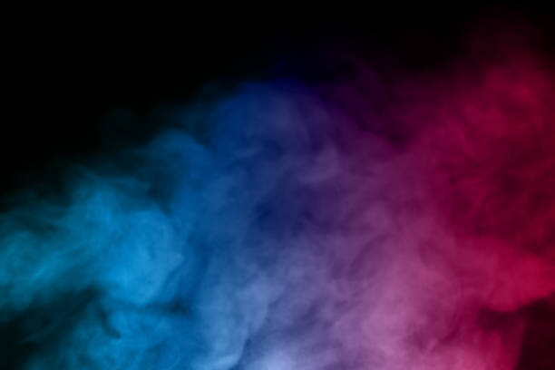 close-up of floating colorful steam smoke spray isolated on a black background