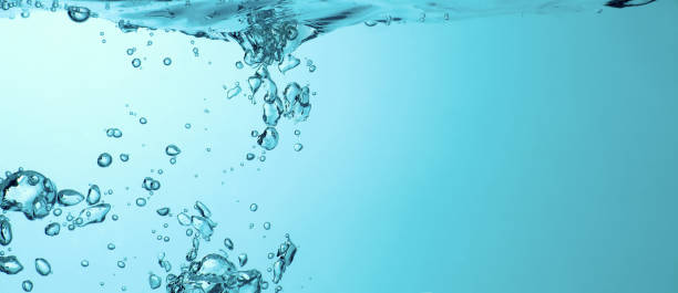 istock Blue bubbles underwater flowing up to the surface 1347081980