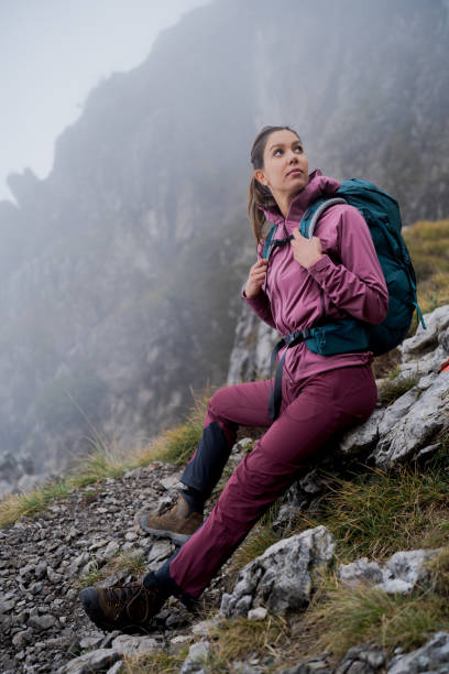 istock Female hiker relaxes on mountain ridge before storm 1347084997