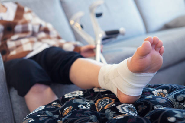 istock Person with a sprained ankle recovering at home 1347085802