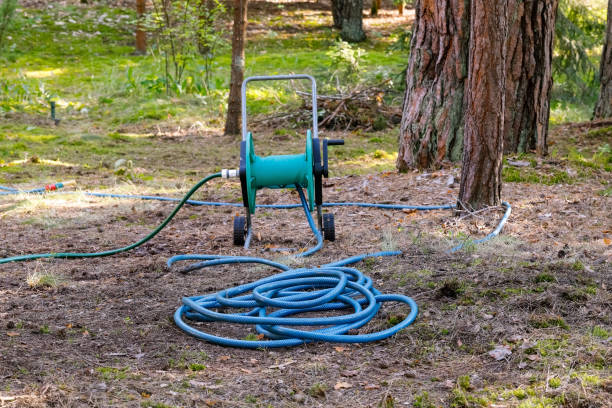 Garden hose unrolled from a reel stock photo