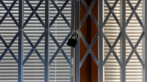 istock There is a steel folding grille in front of a closed window 1347086867