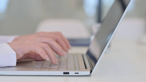 istock Female Hands Typing on Laptop, Close up 1347087028