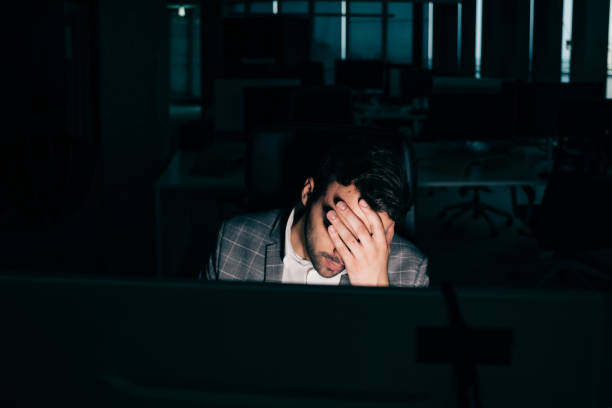 istock Young businessman tired at work at night 1347088410