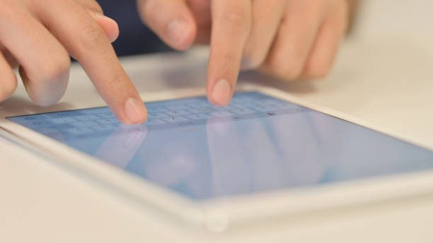 istock Close up of Male Hands using Tablet, scrolling 1347088854