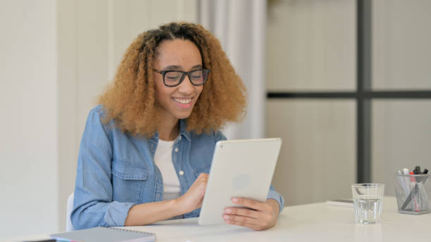 istock Video Call on Tablet by Beautiful African Woman at Work 1347089710