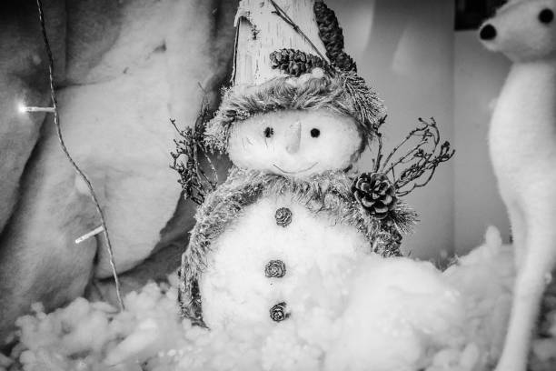 istock Christmas greeting card with snowman in the snow 1347089920