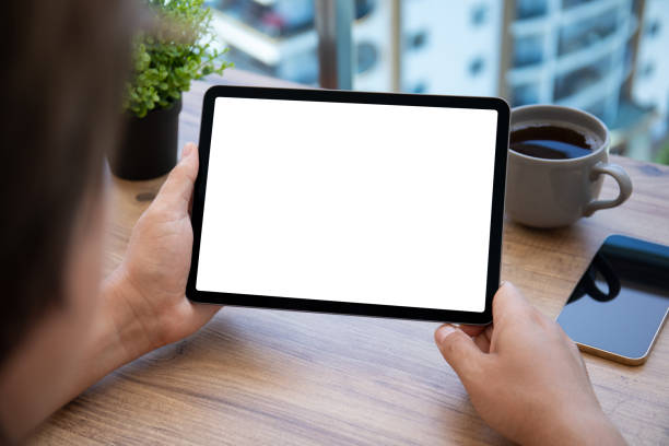 istock male hand holding computer tablet with isolated screen in office 1347092043