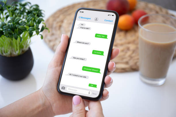 istock female hands holding phone with app messenger on the screen 1347092594