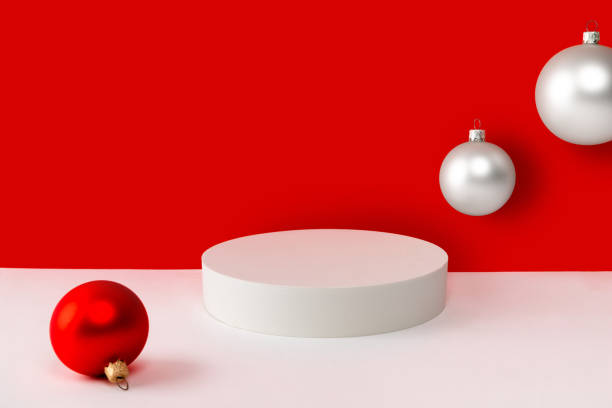 istock Podium with christmas ornaments on red and white creative background. Mock up template for product display. 1347093655