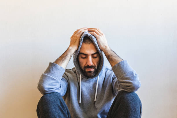 istock Man sitting alone at home, sad emotion 1347094689