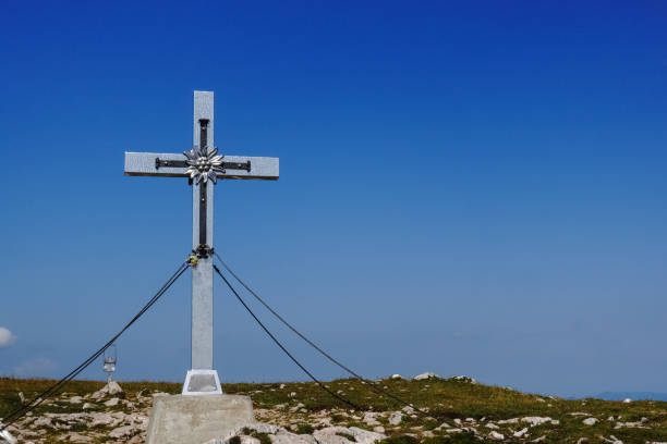 istock silver summit cross and deep blue sky in the summer 1347096152