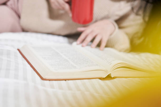 istock A young woman drink coffee and read book 1347096203