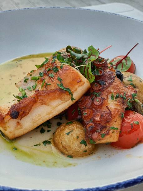 istock Octopus fried with garlic on fava salsa with olives and cherry 1347097056