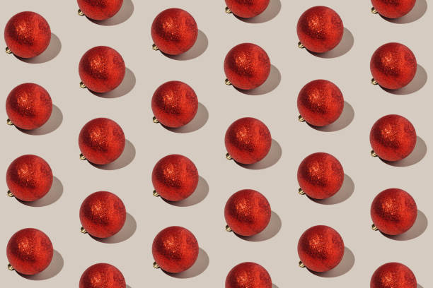 istock Simple pattern made of red baubles on pastel background. Creative winter composition. Christmas party and festive concept. Minimal style. 1347098991