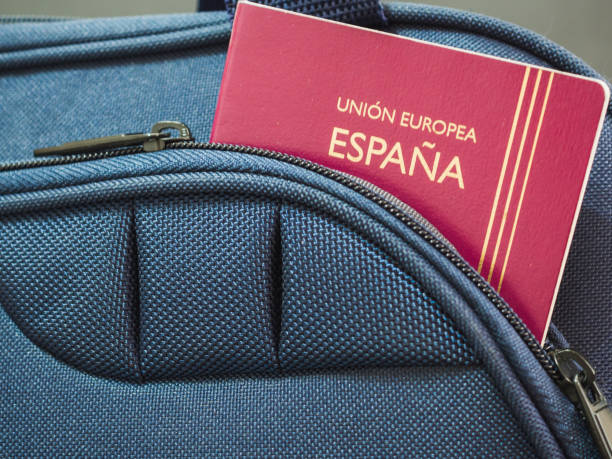 istock Spanish passport in blue suitcase. Travel concept 1347100940