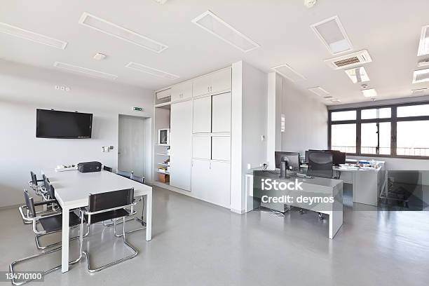 Modern Office With White Furniture Cupboard And Conference Desk Stock Photo - Download Image Now